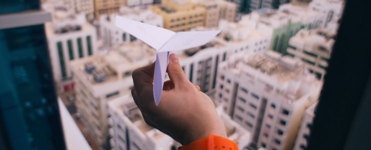 Paper Airplane Overlooking City